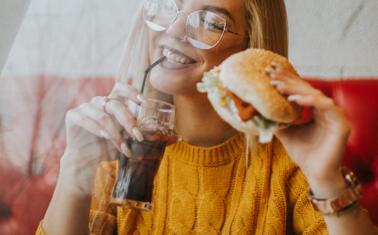 happy woman eating a burger