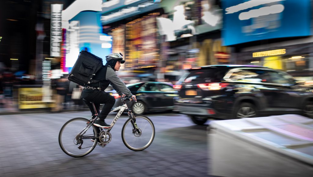 delivery man riding a bike