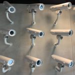 lots of security cameras on a wall