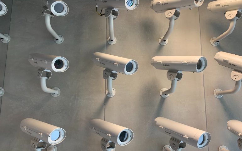 lots of security cameras on a wall